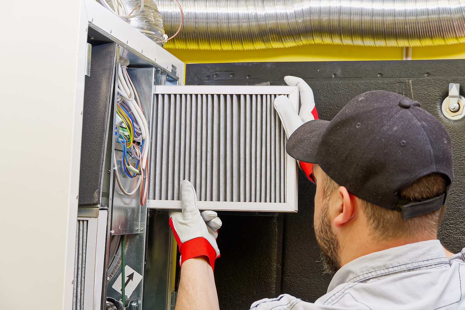 HVAC technician changing filter in Carmel, IN
