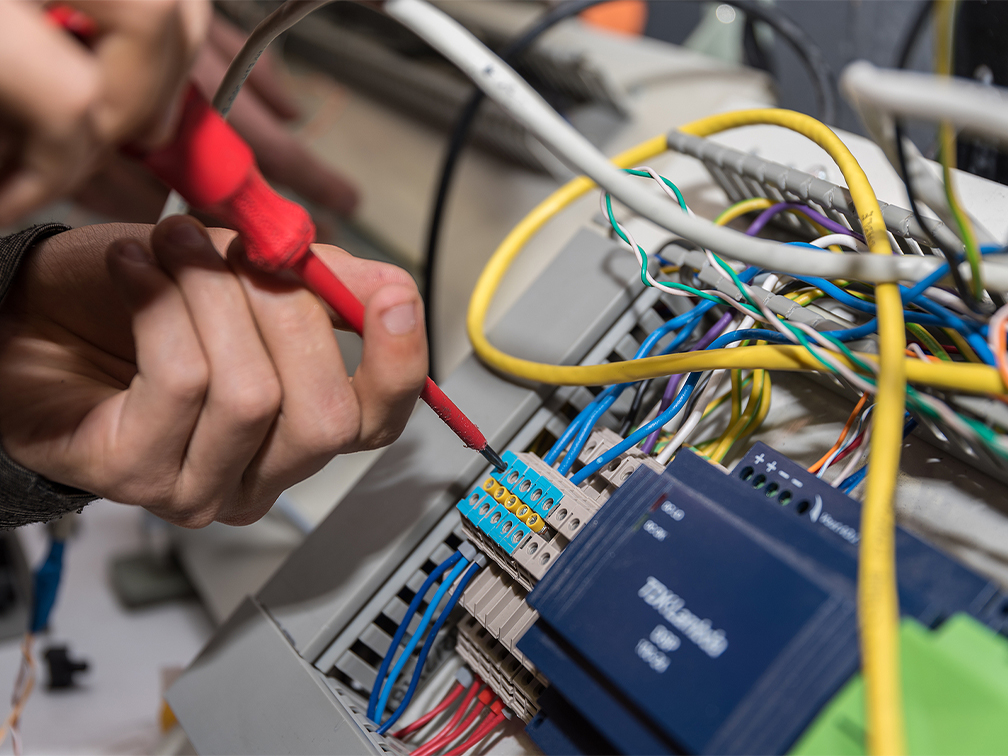 Instructor teaching electrical equiment to student